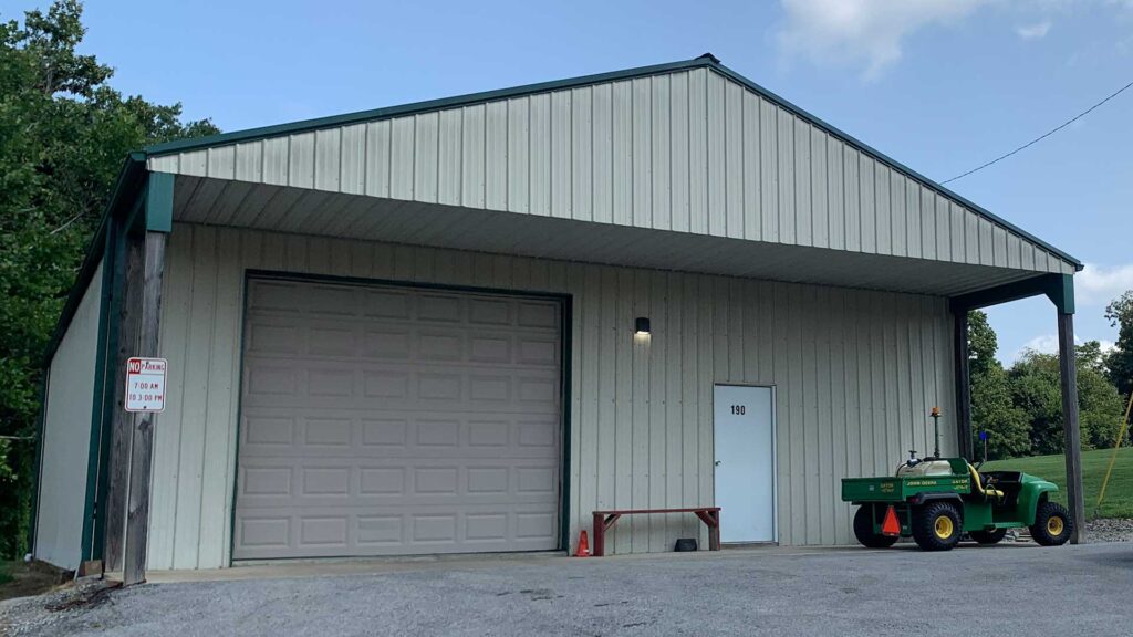 Campbellsville Parks Department building with garage bay, side entrance door, and maintenance utility vehicle parked outside.